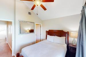 a bedroom with a bed and a ceiling fan at Coconut House in Duck Key