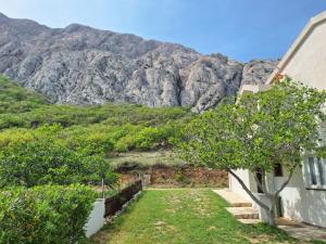 a house with a mountain in the background at Pag House in Pag
