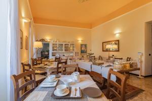 una sala da pranzo con un lungo tavolo e sedie di Villa Salvarezza a Noli
