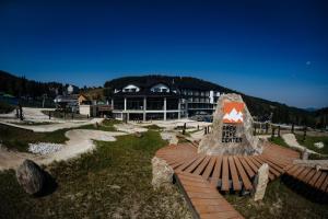 a large building with a sign in front of it at Apartment BIKE PARK Czarna Góra Resort in Sienna