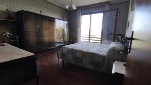 a bedroom with a bed and a large window at Villa Elisa in Cuccurano