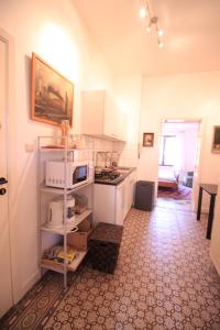 a kitchen with white cabinets and a stove top oven at Cozy studio close to Zaventem Airport in Brussels +2 photos