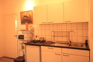 a small kitchen with a sink and a stove at Cozy studio close to Zaventem Airport in Brussels