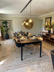 a dining room with a large table with chairs at La Magnanerie in Ménerbes