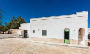 a white building with green doors on it at Villa Mati in Macchia di Monte +39 photos