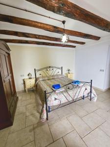 a bedroom with a bed in a room with wooden ceilings at Tenuta La Panoramica in Castellabate