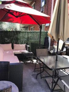 a patio with a table and an umbrella and chairs at Brooklyn Spring Getaway with Outdoor space in Brooklyn