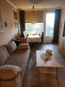 a living room with a couch and a table at FeWo "Zitadelle" in Kellenhusen/Ostsee in Kellenhusen