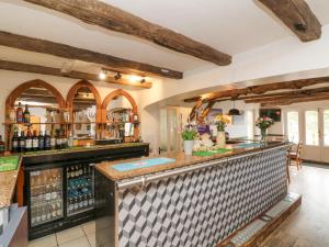 a bar in a kitchen with wooden beams at 18 Manleigh Park in Ilfracombe