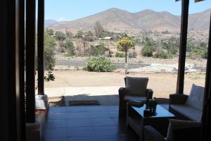 a living room with a view of the mountains at Hostal El Valle in Illapel