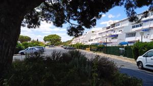 a street with cars parked on the side of a building at Apartamento Pleamar in El Rompido +14 photos