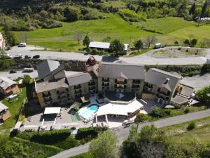 an aerial view of a house with a swimming pool at Hotel-Restaurant La Lauzétane in Le Lauzet-Ubaye