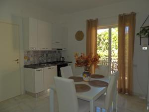 una cucina con tavolo e sedie e una cucina con finestra di Dolphin House a Pompei