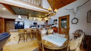 a kitchen and dining room with a glass table and chairs at Horsin Around Tennessee in Townsend