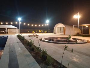 einen Skatepark in der Nacht mit Pool und Lichtern in der Unterkunft Desert Breeze in Al Ḩamrānīyah