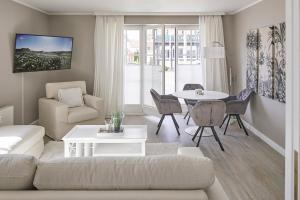 a living room with a couch and a table at Techts Strandhaus in Timmendorfer Strand