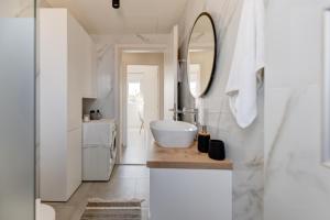 a bathroom with a sink and a mirror at Newly Built Home with Garden, 400m to Beach in Kokkíni Khánion +24 photos