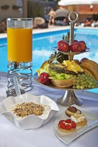 a table with two plates of food and a glass of orange juice at Congo Palace in Athens