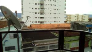 a surfboard sitting on the roof of a building at Apto. Cid. Ocian in Praia Grande