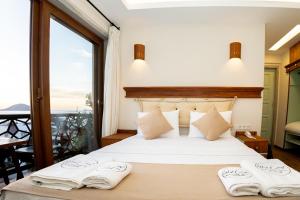 a bedroom with a bed with two towels on it at west coast boutique hotel in Bodrum City