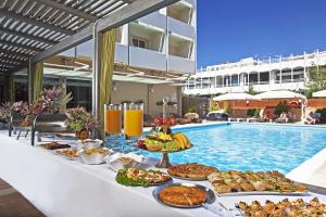 a buffet of food next to a swimming pool at Congo Palace in Athens