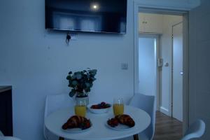 a white table with two plates of food on it at Excellent one bedroom apartment Dundee in Dundee