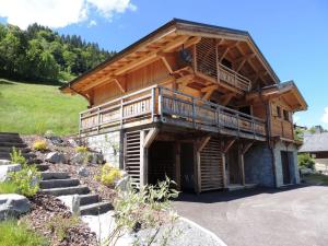 a large wooden house with a balcony and stairs at Chalet Les Gets, 4 pièces, 6 personnes - FR-1-598-10 in Les Gets