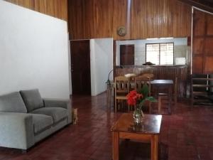 a living room with a couch and a table at Almendros House in Coco