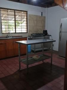 uma cozinha com uma mesa no meio em Almendros House em Coco