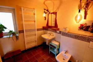 a bathroom with a sink and a toilet at Villa Aurora Sotto Le Stelle in Torre Pellice