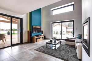 a living room with a couch and a tv at Ici on est à Laiz in Laiz