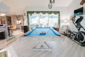 a living room with a pool table in it at steve and cori's tropical king suite 2 in North Port