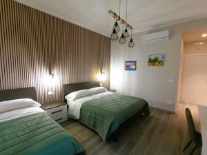 Un pat sau paturi într-o cameră la BariVera rooms
