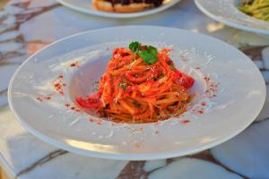 a white plate of food on a table at west coast boutique hotel in Bodrum City