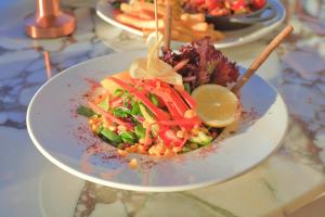 a plate of food with a salad on a table at west coast boutique hotel in Bodrum City