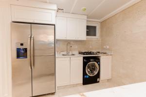 a kitchen with a refrigerator and a washing machine at Studio Apartment - Maadi in Cairo