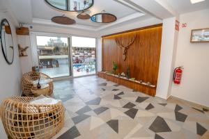 a living room with wicker chairs on a checkered floor at west coast boutique hotel in Bodrum City