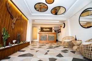 a lobby with a reception area with a fireplace and mirrors at west coast boutique hotel in Bodrum City