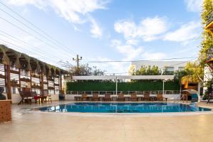 a large swimming pool with chairs and a table at west coast boutique hotel in Bodrum City