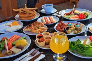 a table with many plates of food on it at west coast boutique hotel in Bodrum City