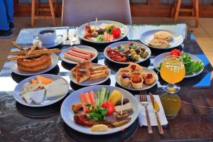 a table with many plates of food on it at west coast boutique hotel in Bodrum City