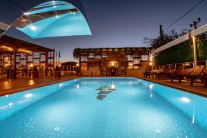 a large blue swimming pool in a building at west coast boutique hotel in Bodrum City