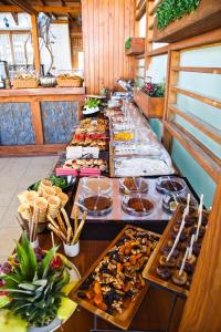 a buffet line with many different types of food at west coast boutique hotel in Bodrum City