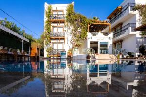 a hotel with a pool in front of a building at west coast boutique hotel in Bodrum City