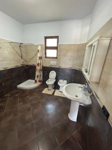 a bathroom with two toilets and a sink at Villa Bordeaux in Rrashbull +27 photos