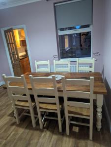 a dining room with a wooden table and chairs at Spacious 2-Bed House in Newark in Newark-on-Trent
