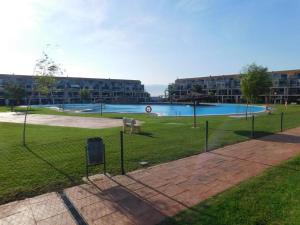 a fence in a park with a swimming pool at Casa en Panorámica Golf, Sant Jordi in Sant Jordi