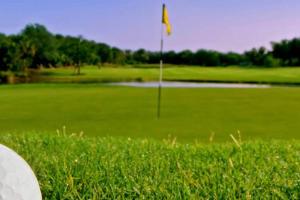 a golf course with a flag in the grass at Casa en Panorámica Golf, Sant Jordi in Sant Jordi