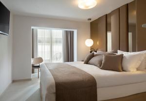 a bedroom with a large bed and a large window at Alexandrion Appartments Down Town Adults Only in Sarti