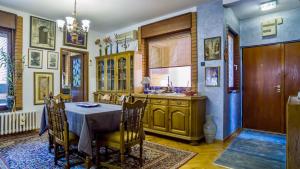 a dining room with a table and a kitchen at 105 m2 Apartment in a Diplomatic Area in Belgrade